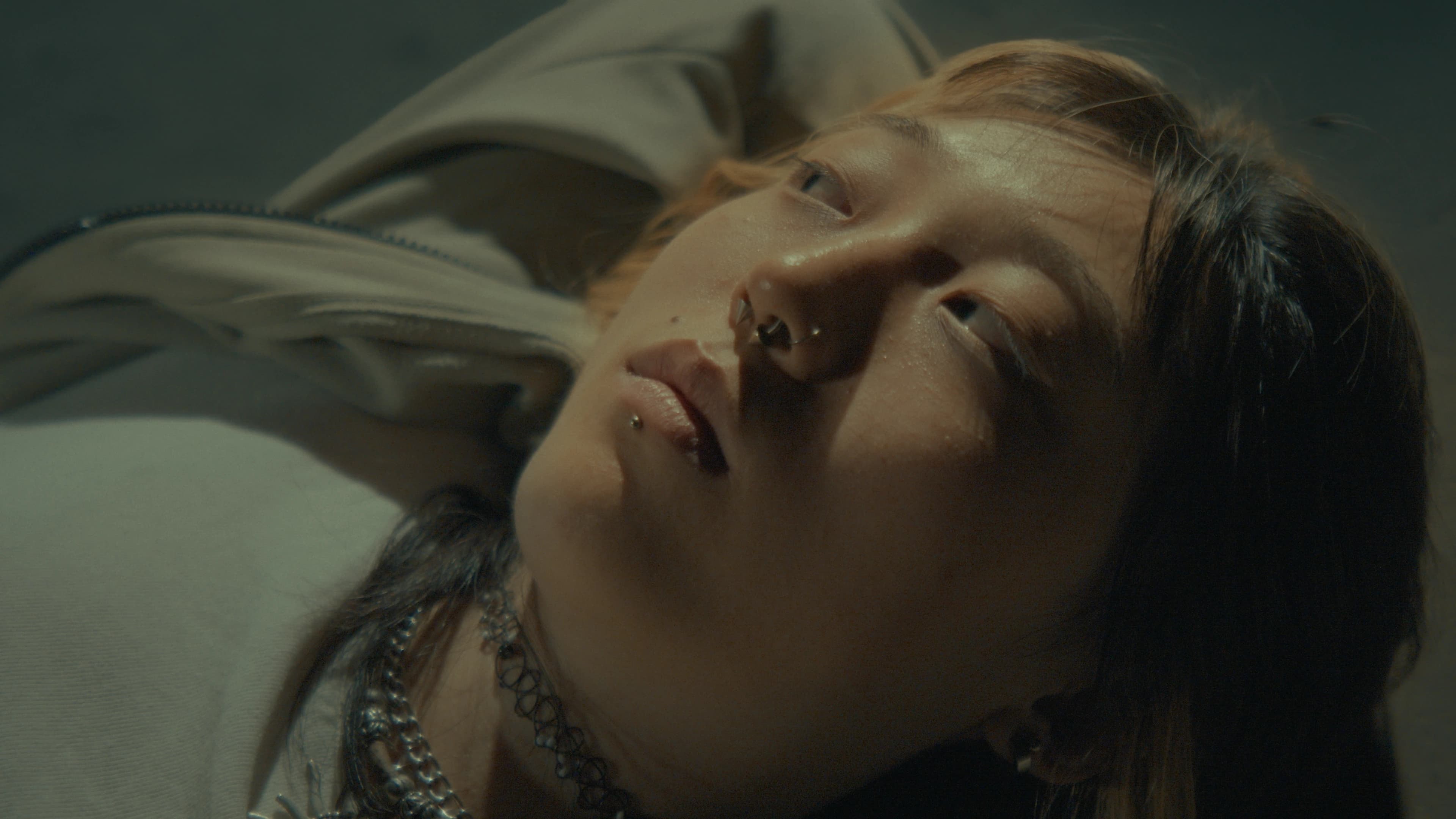 Still from Spiraling Out: close-up of a person lying down.